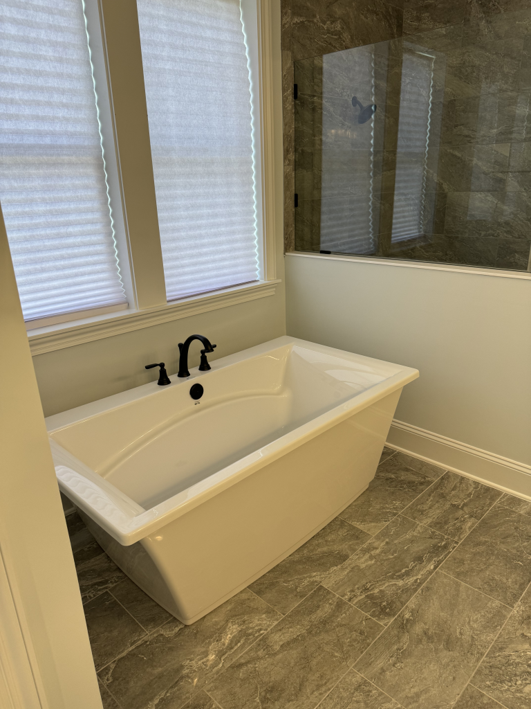Modern bathroom remodeling with elegant design, new tiles, and functional fixtures by Neves Construction.