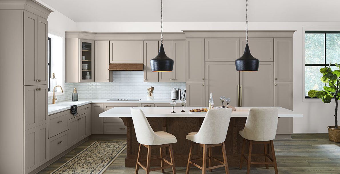 Modern kitchen remodel in Florida featuring custom cabinets, quartz countertops, island, and stylish lighting